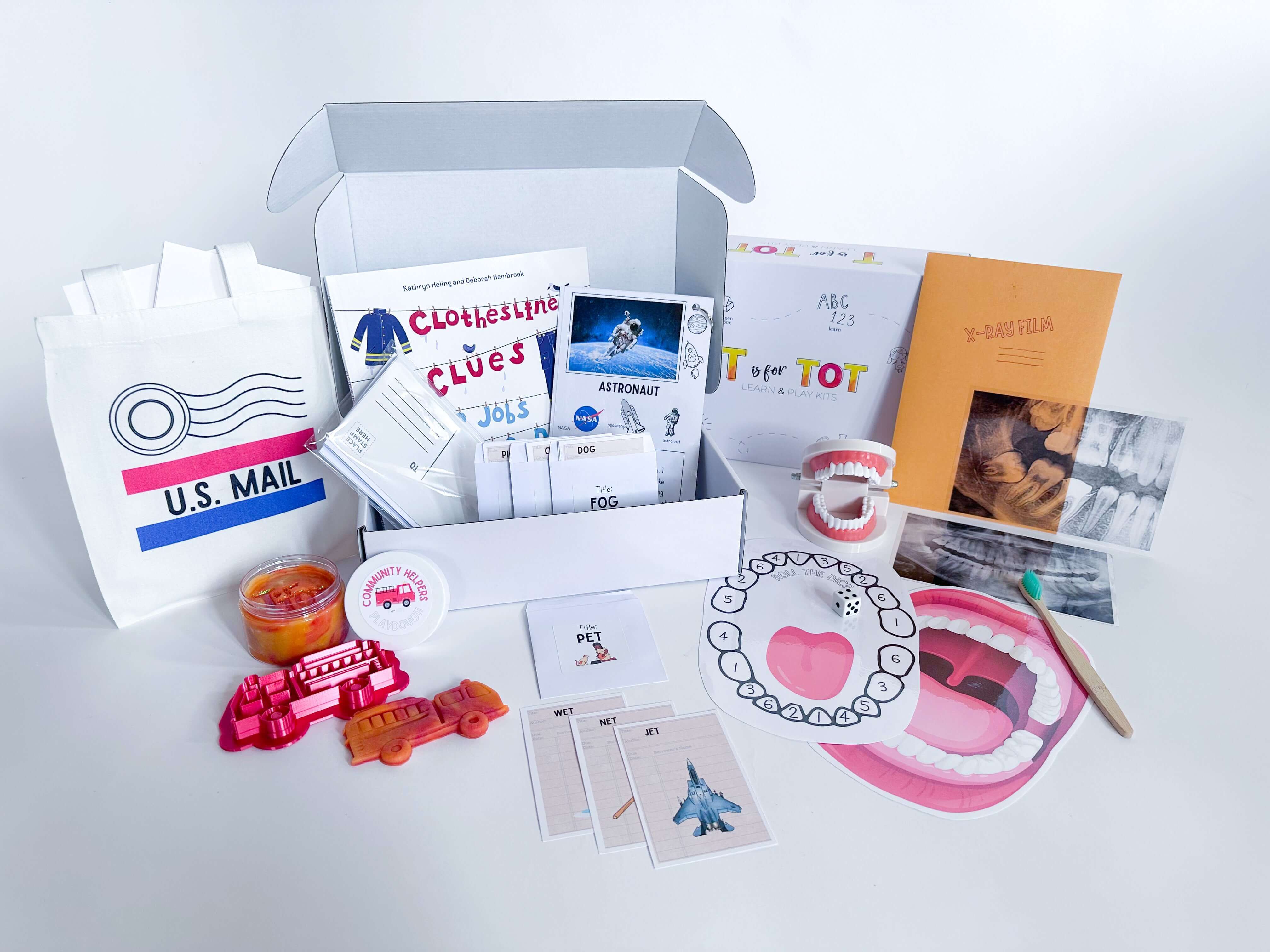 Community Helpers play and learn kit for kids aged 3-6. Includes fire engine playdough cutter, homemade playdough, dental x-rays, library card rhyming game, mailbag and letters, and pretend play activities to explore important community jobs. Features a